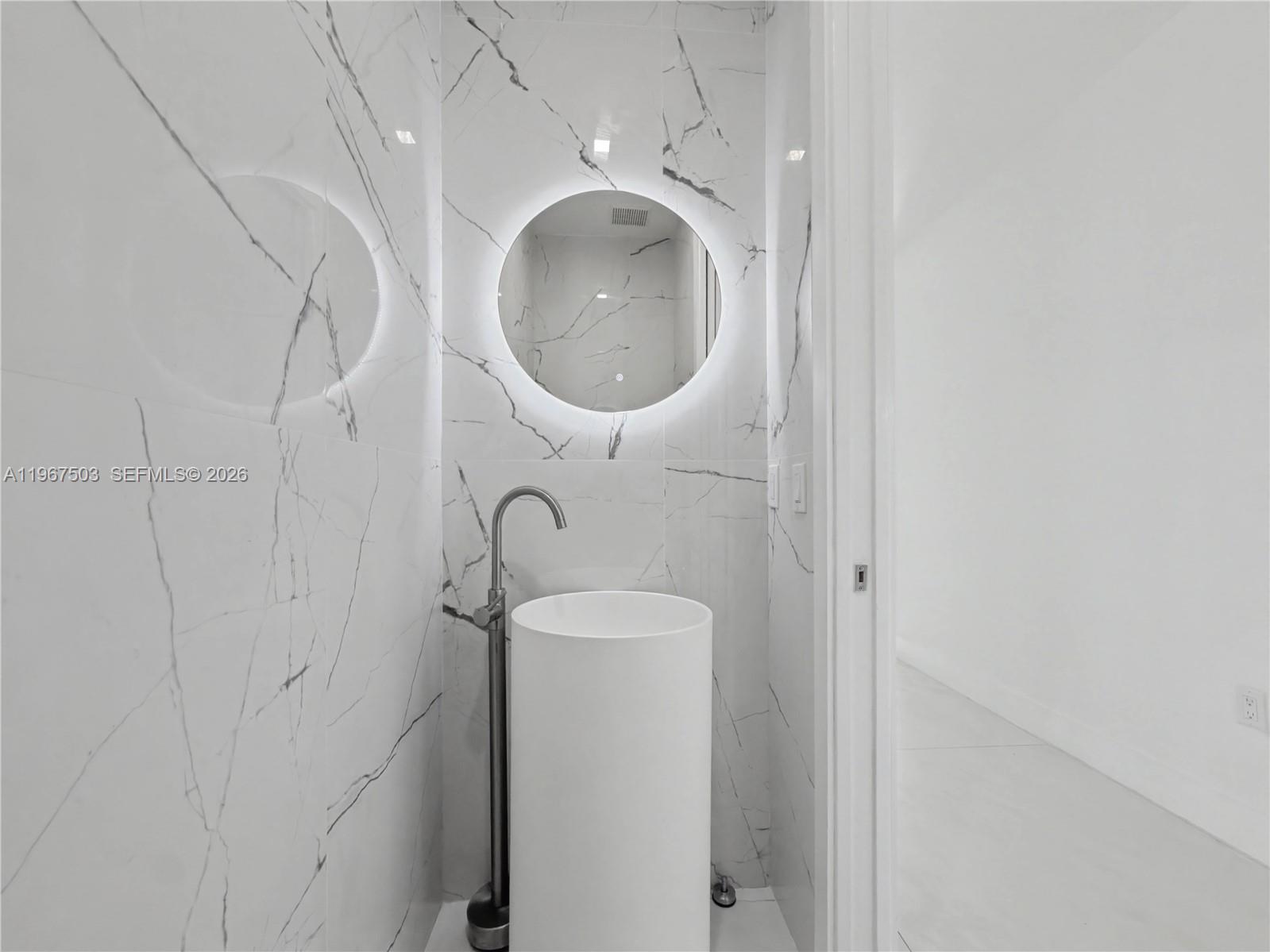 7733 Southwest 193rd Street Cutler Bay, FL 33157 - Photo 19 of 36 a bathroom with a sink and a mirror