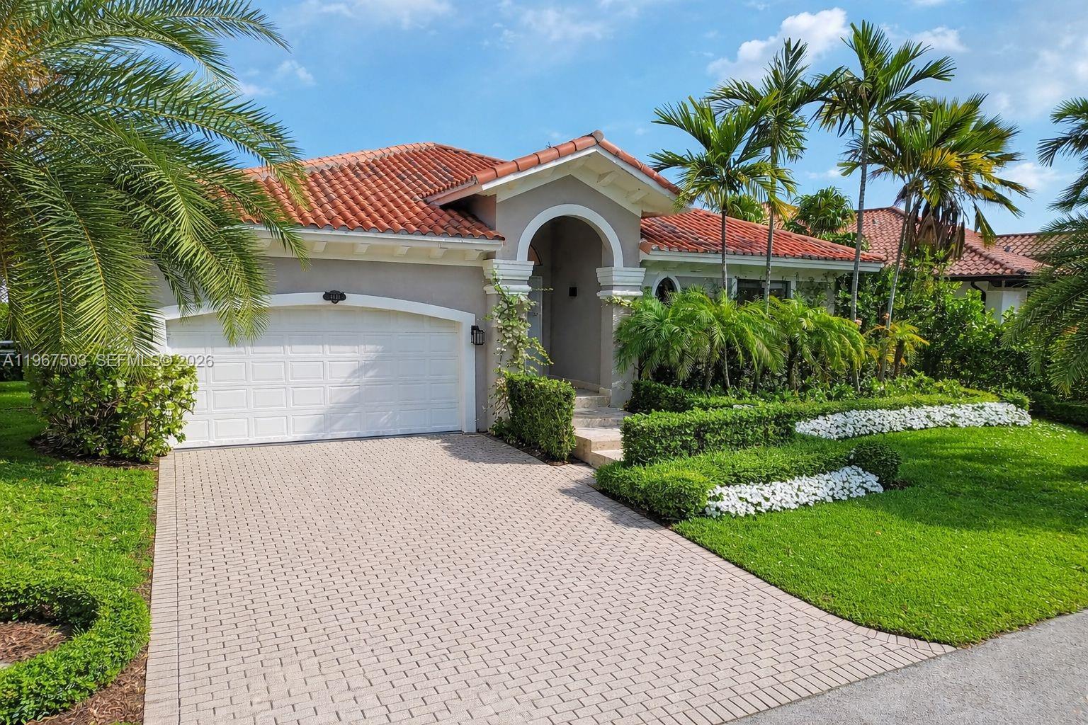 7733 Southwest 193rd Street Cutler Bay, FL 33157 - Photo 2 of 36 a front view of a house with a yard and garage