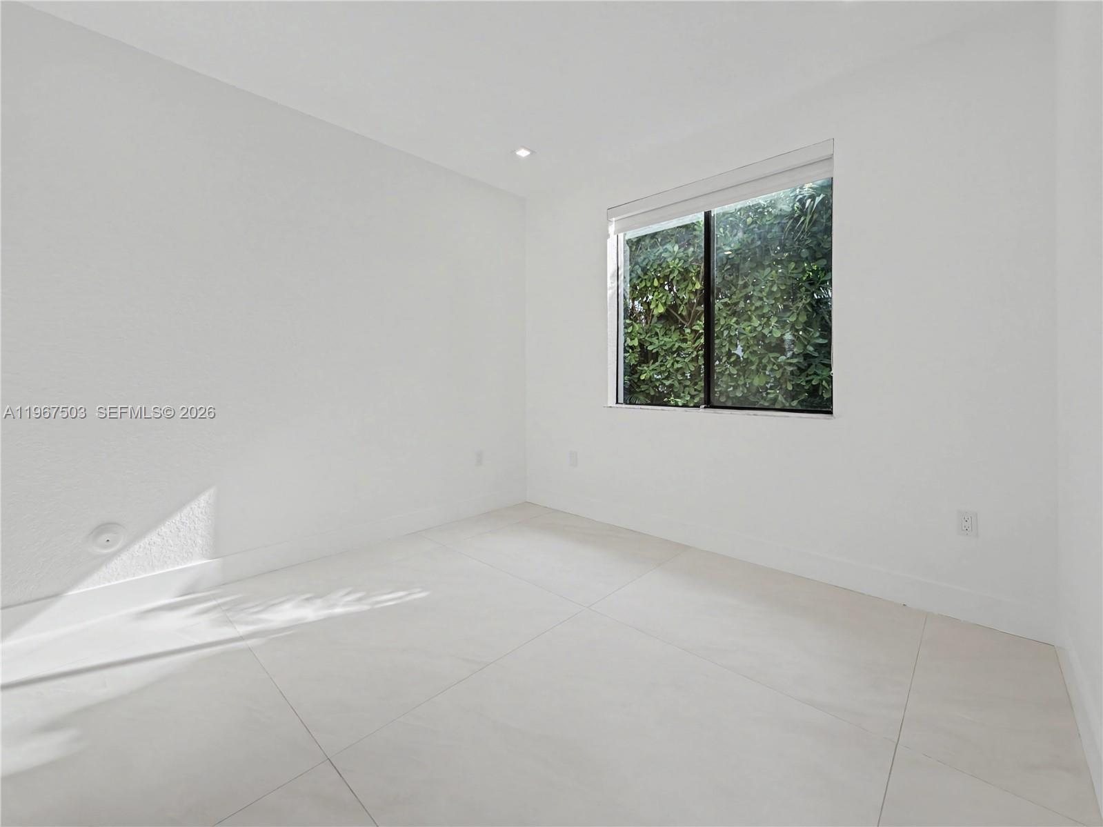 7733 Southwest 193rd Street Cutler Bay, FL 33157 - Photo 21 of 36 an empty room with a window