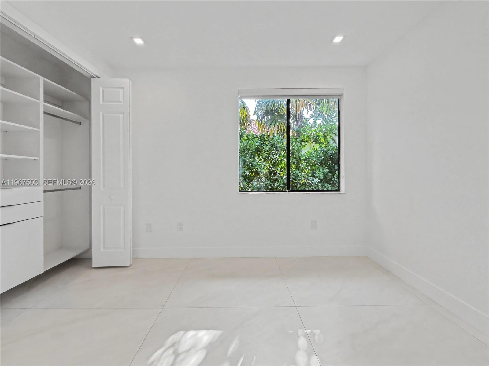 7733 Southwest 193rd Street Cutler Bay, FL 33157 - Photo 22 of 36 an empty room with windows