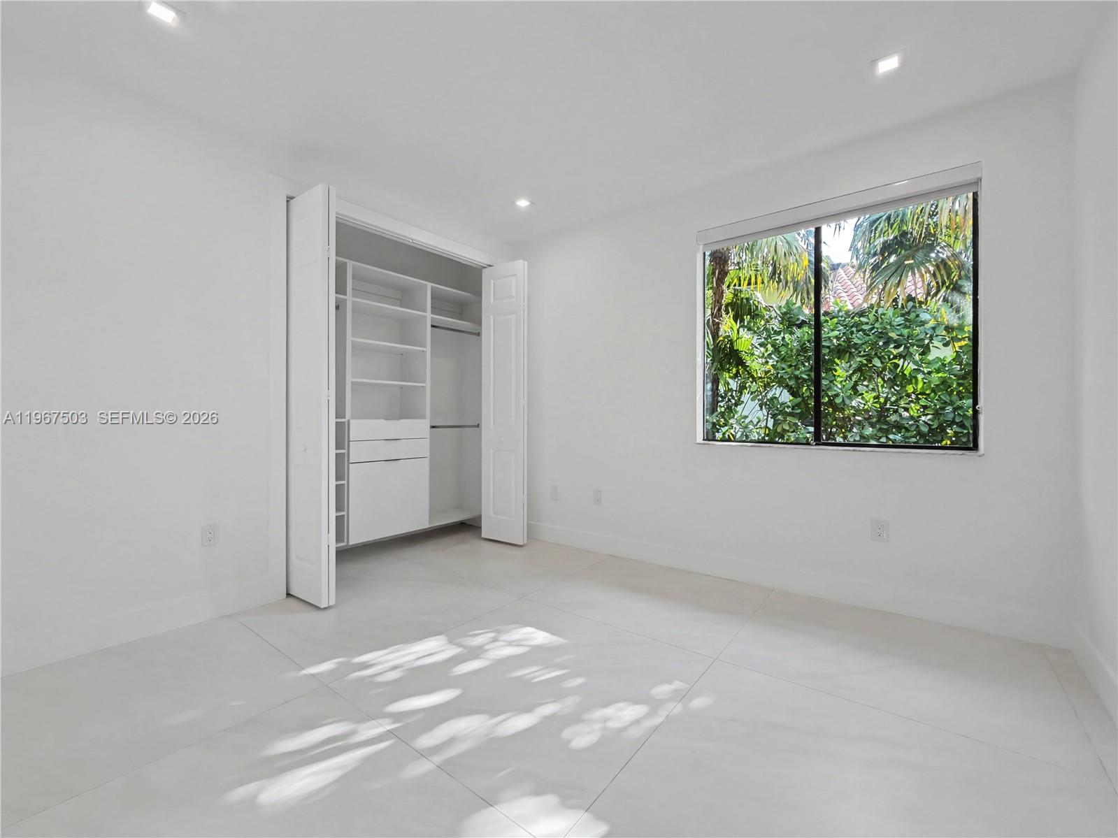 7733 Southwest 193rd Street Cutler Bay, FL 33157 - Photo 23 of 36 an empty room with a window