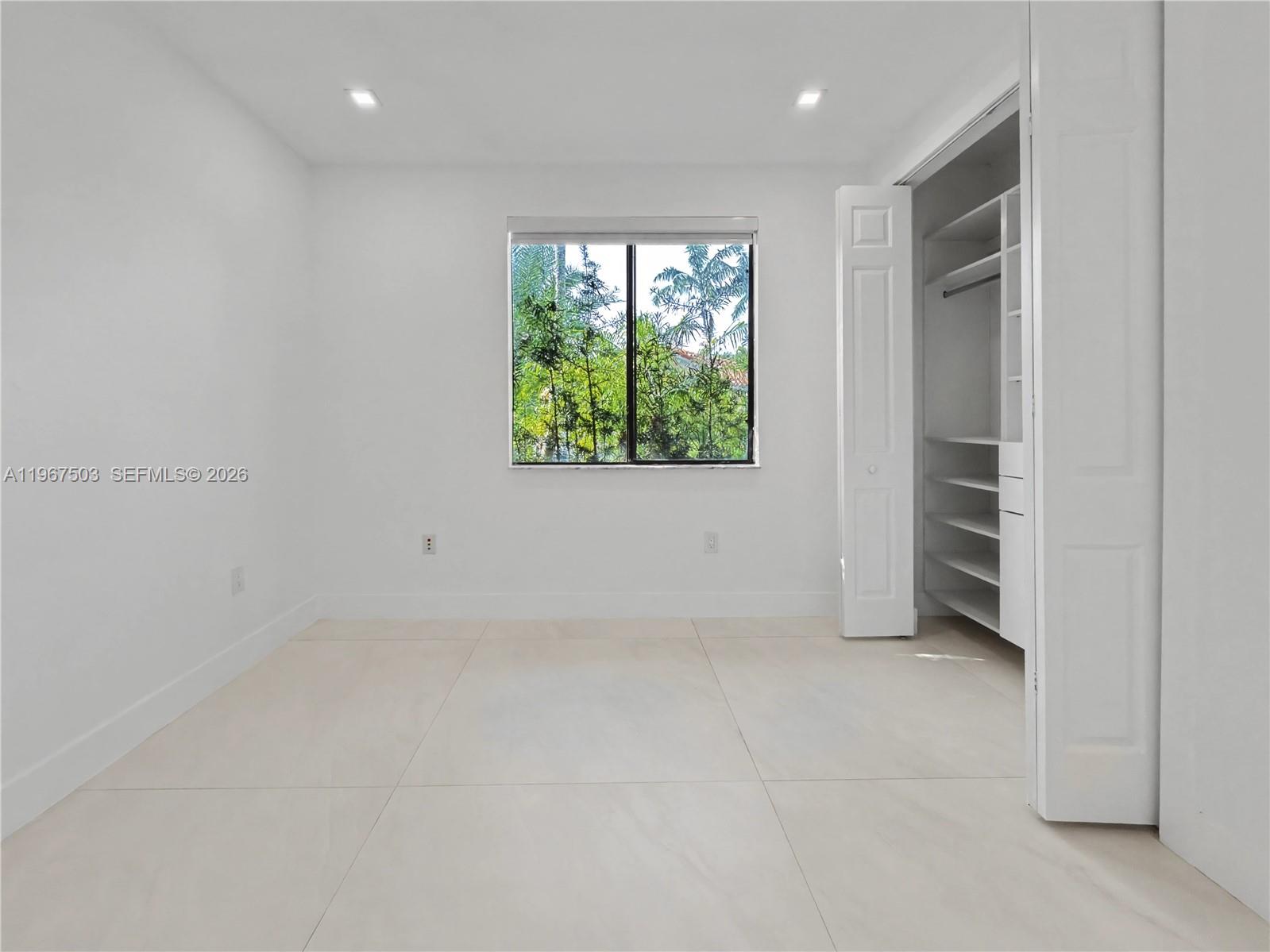 7733 Southwest 193rd Street Cutler Bay, FL 33157 - Photo 24 of 36 an empty room with a window
