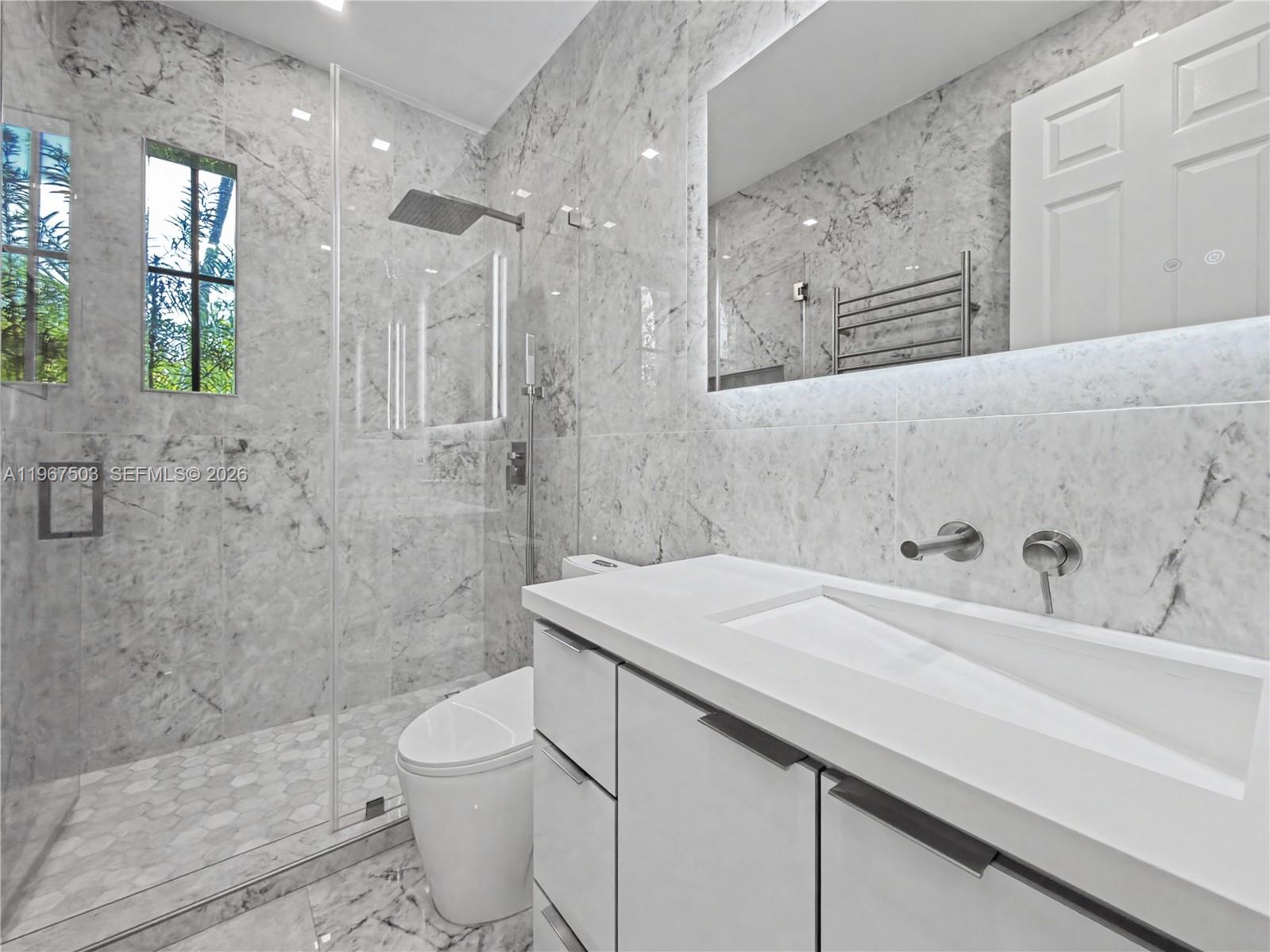 7733 Southwest 193rd Street Cutler Bay, FL 33157 - Photo 26 of 36 a bathroom with a sink a toilet and shower