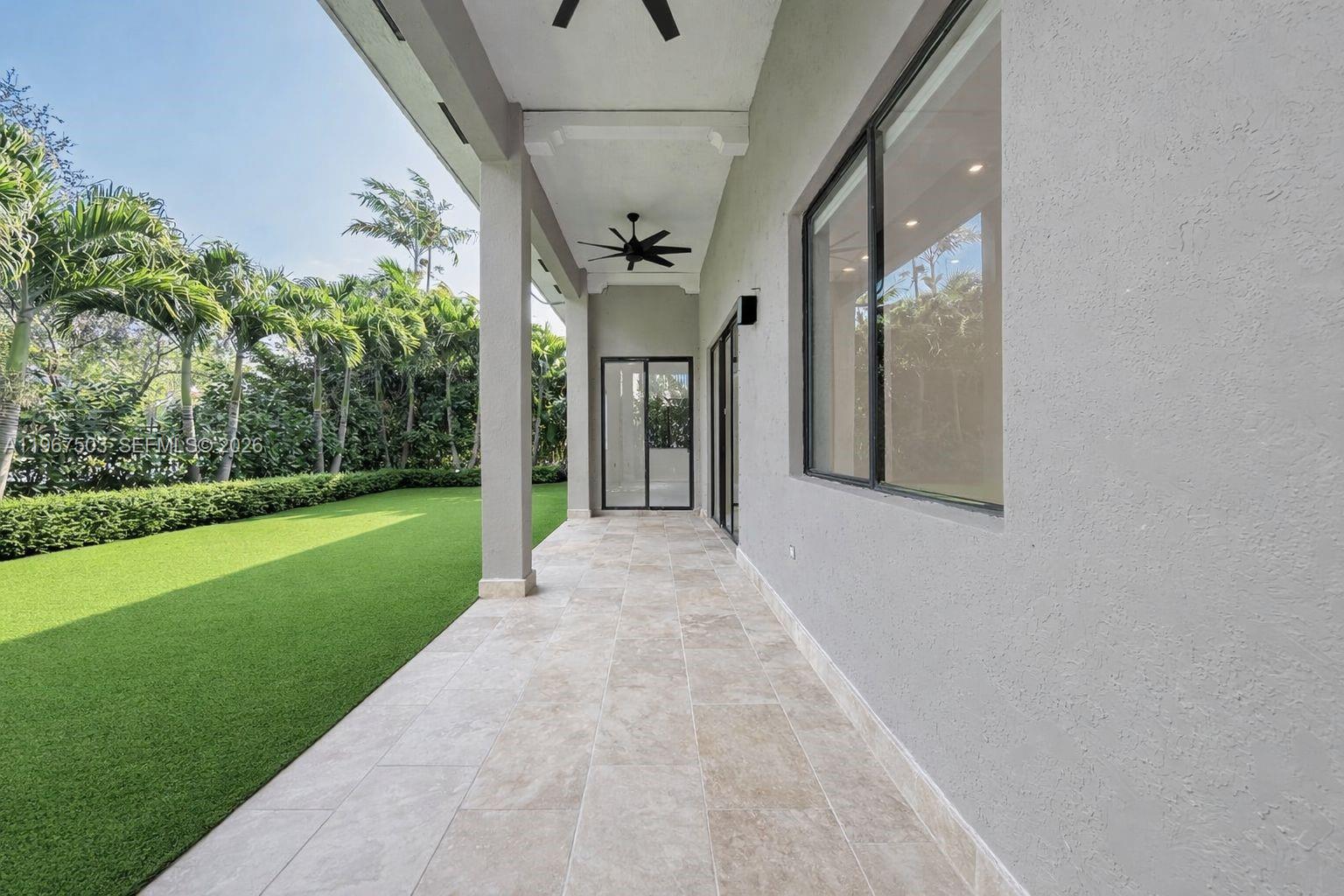 7733 Southwest 193rd Street Cutler Bay, FL 33157 - Photo 28 of 36 a view of a house with a big yard and potted plants