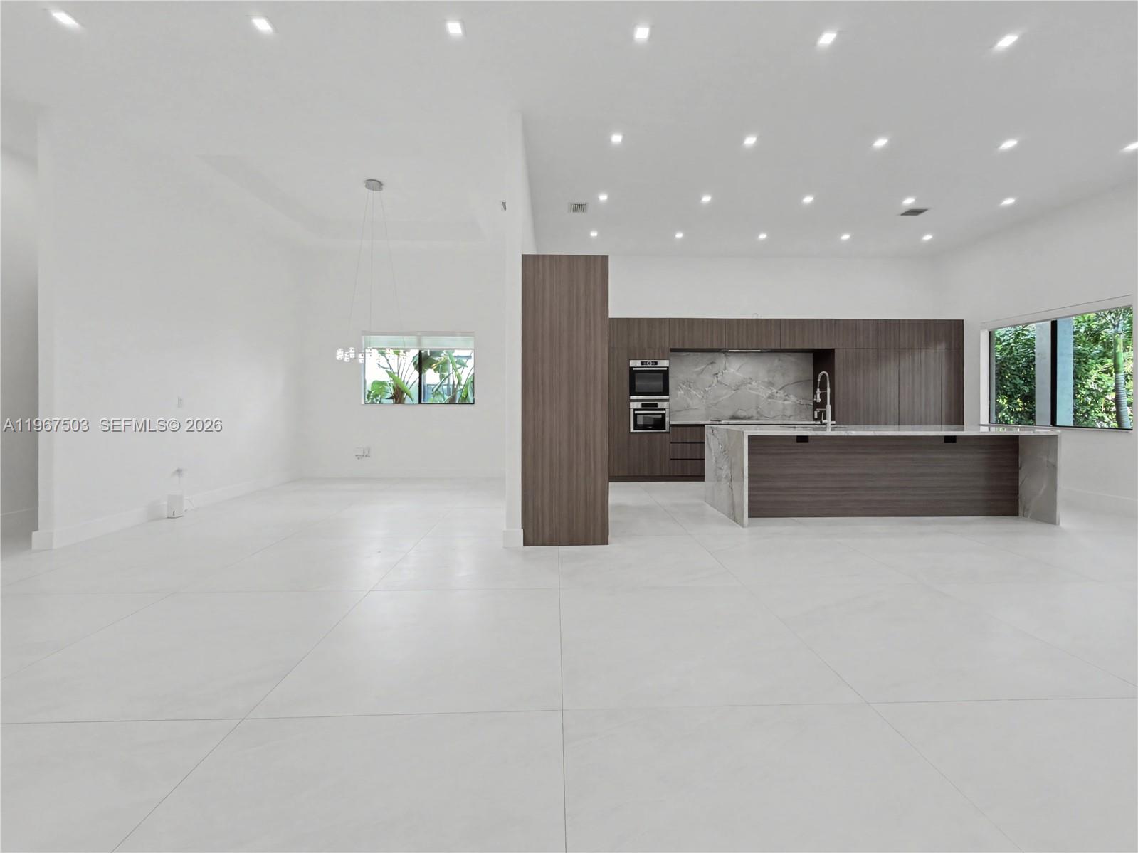 7733 Southwest 193rd Street Cutler Bay, FL 33157 - Photo 6 of 36 a view of kitchen with stainless steel appliances a refrigerator and a sink