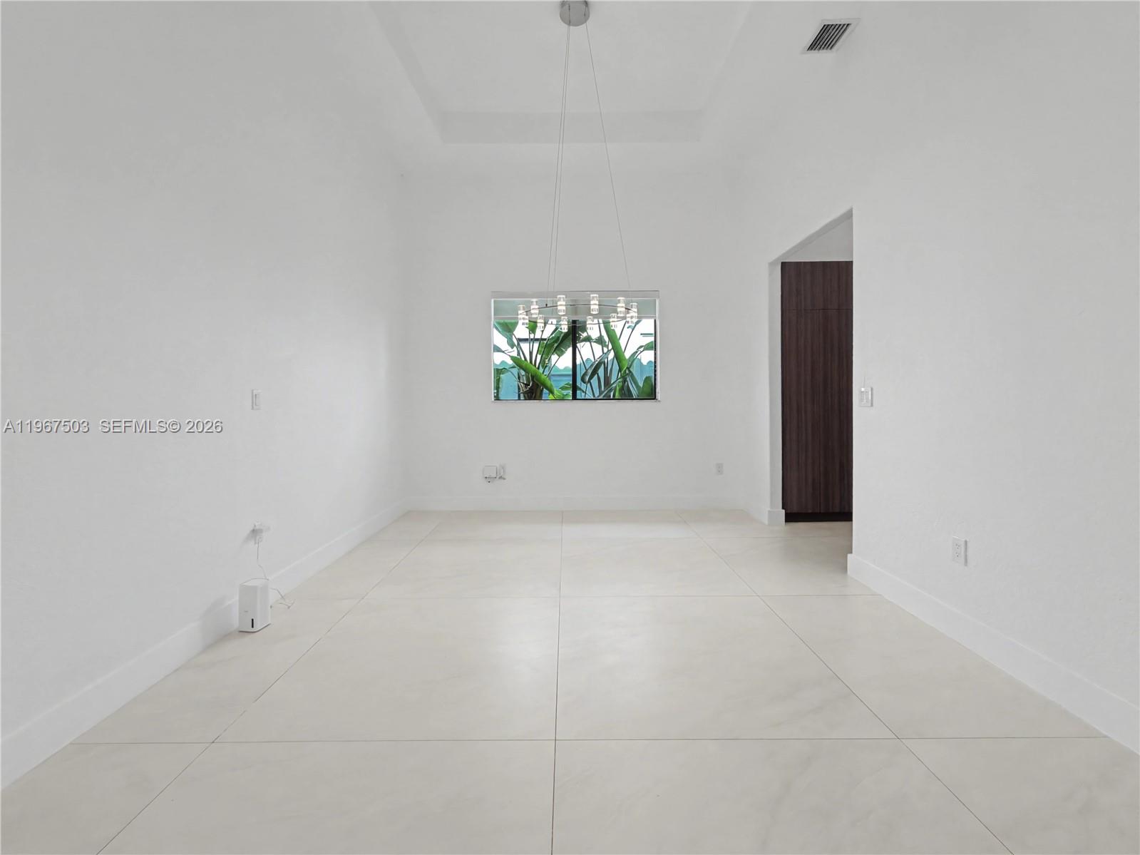 7733 Southwest 193rd Street Cutler Bay, FL 33157 - Photo 7 of 36 an empty room with windows