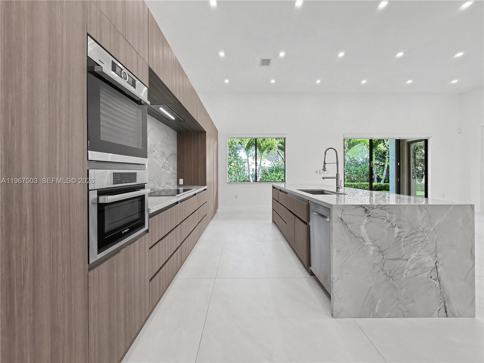 7733 Southwest 193rd Street Cutler Bay, FL 33157 - Photo 10 of 36 a large kitchen with stainless steel appliances a large counter top