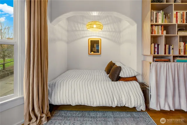 a bedroom with a bed and a book shelf