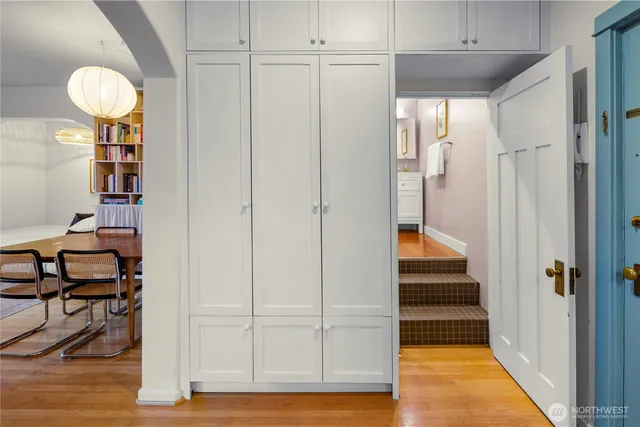 a view of a hallway with entryway wooden floor and front door