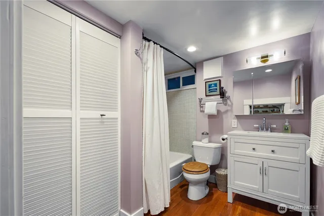 a bathroom with a toilet a sink and a mirror