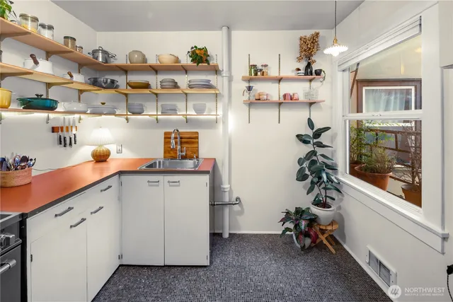 a view of a kitchen with fridge and workspace