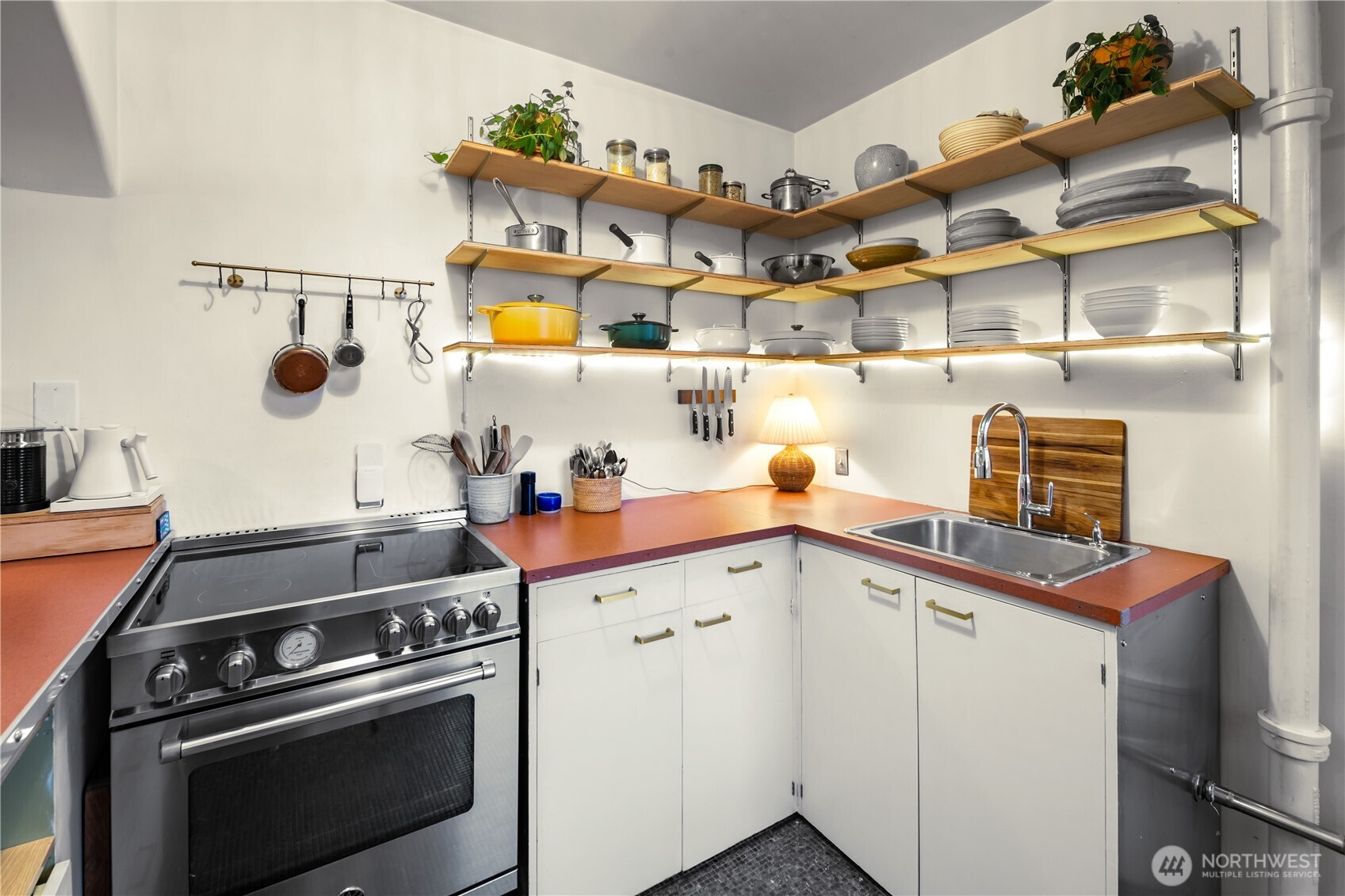 1732 15th Avenue, Unit 27 Seattle, WA 98122 - Photo 10 of 27 a kitchen with a stove and cabinets
