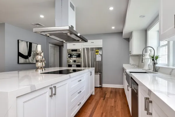 a kitchen with granite countertop a sink and cabinets