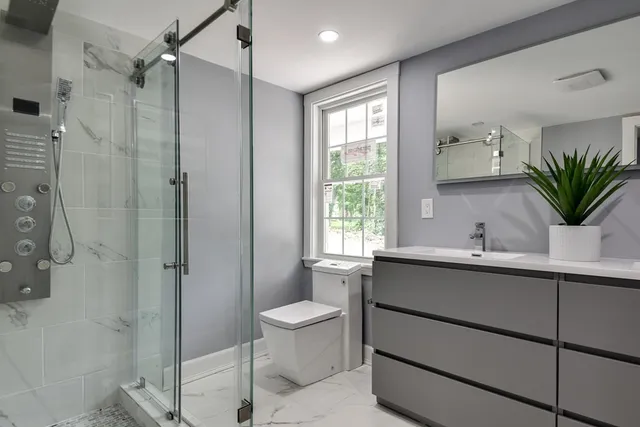 a bathroom with a sink toilet and shower