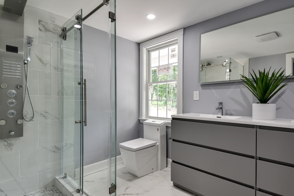 18 Damon Street, Unit 18 Wayland, MA 01778 - Photo 13 of 24 a bathroom with a sink toilet and shower