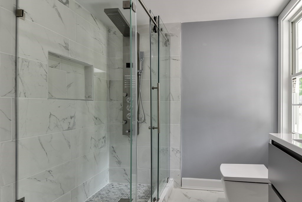 18 Damon Street, Unit 18 Wayland, MA 01778 - Photo 14 of 24 a bathroom with a shower and a toilet