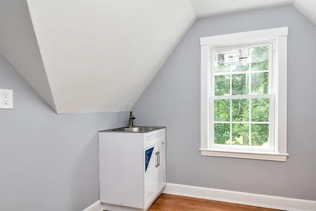 a hallway with window and wooden floor