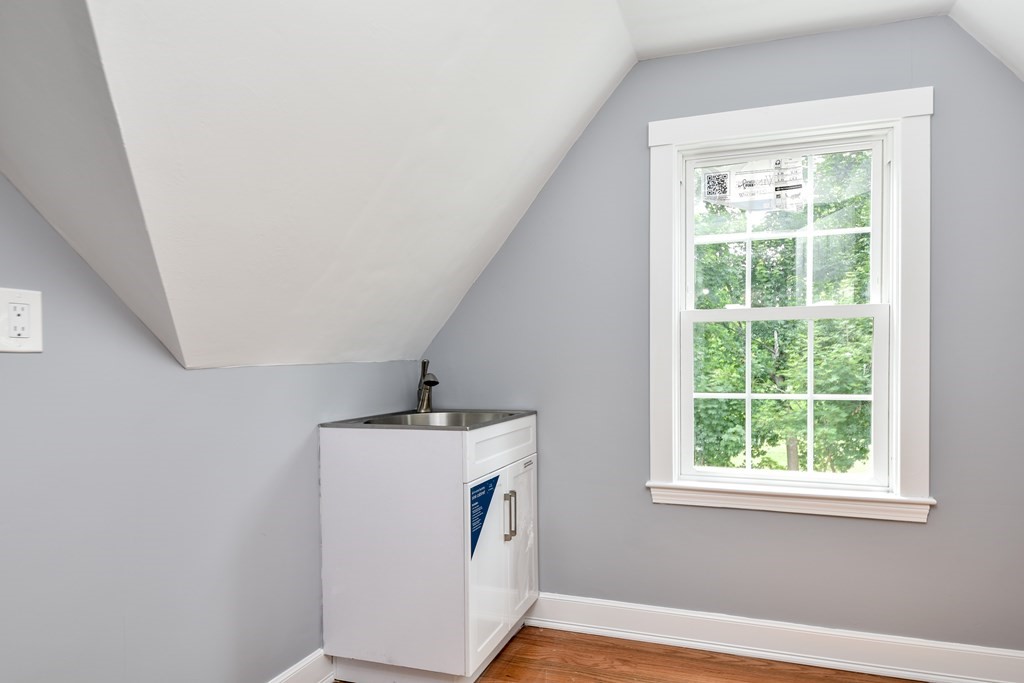 18 Damon Street, Unit 18 Wayland, MA 01778 - Photo 18 of 24 a hallway with window and wooden floor