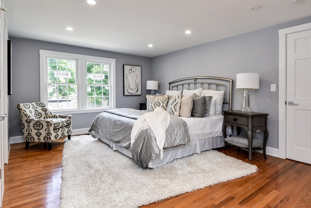 18 Damon Street, Unit 18 Wayland, MA 01778 - Photo 19 of 24 a bed sitting in a spacious bedroom next to a window