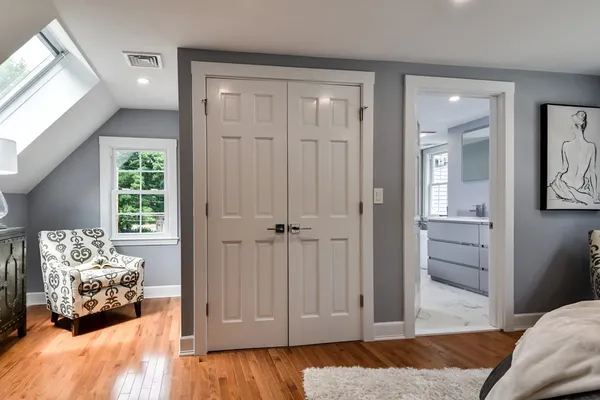 a bedroom with a bed and wooden floor