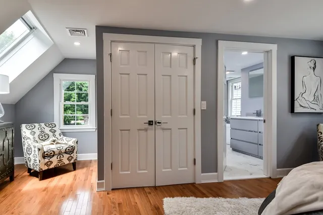 a bedroom with a bed and wooden floor