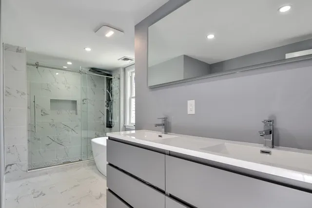 a bathroom with a sink a toilet and shower