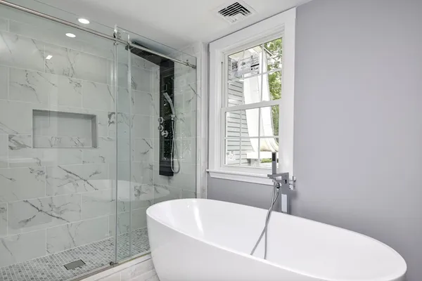 a white bath tub sitting next to a white sink