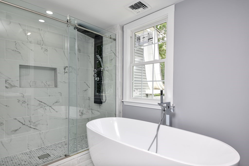 18 Damon Street, Unit 18 Wayland, MA 01778 - Photo 22 of 24 a white bath tub sitting next to a white sink