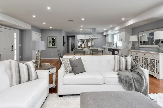 a living room with furniture kitchen view and a couch