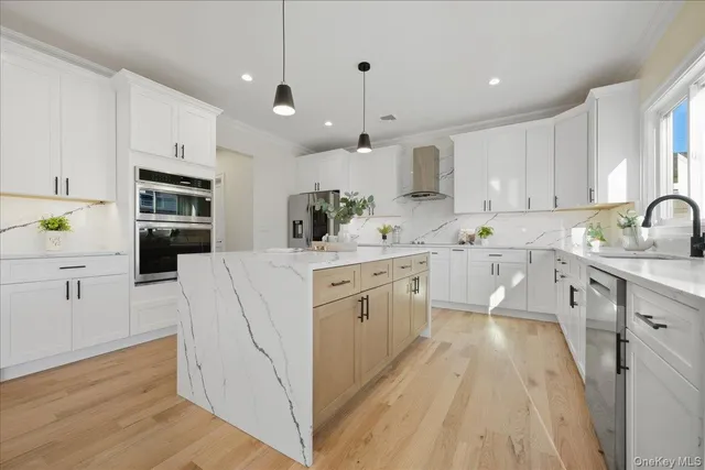 a kitchen with kitchen island white cabinets and white appliances