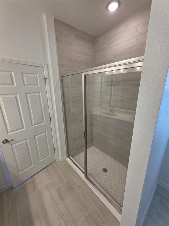 6008 Vision Road St. Cloud, FL 34771 - Photo 26 of 33 a bathroom with a glass door shower