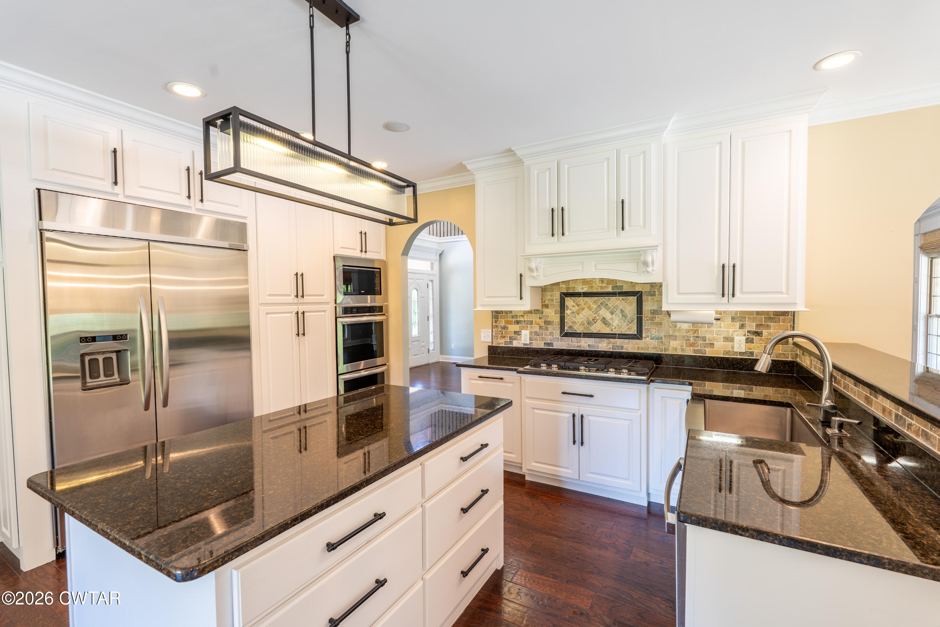 227 Willie Johnson Road Dyersburg, TN 38024 - Photo 12 of 43 a kitchen with stainless steel appliances granite countertop a sink stove and refrigerator