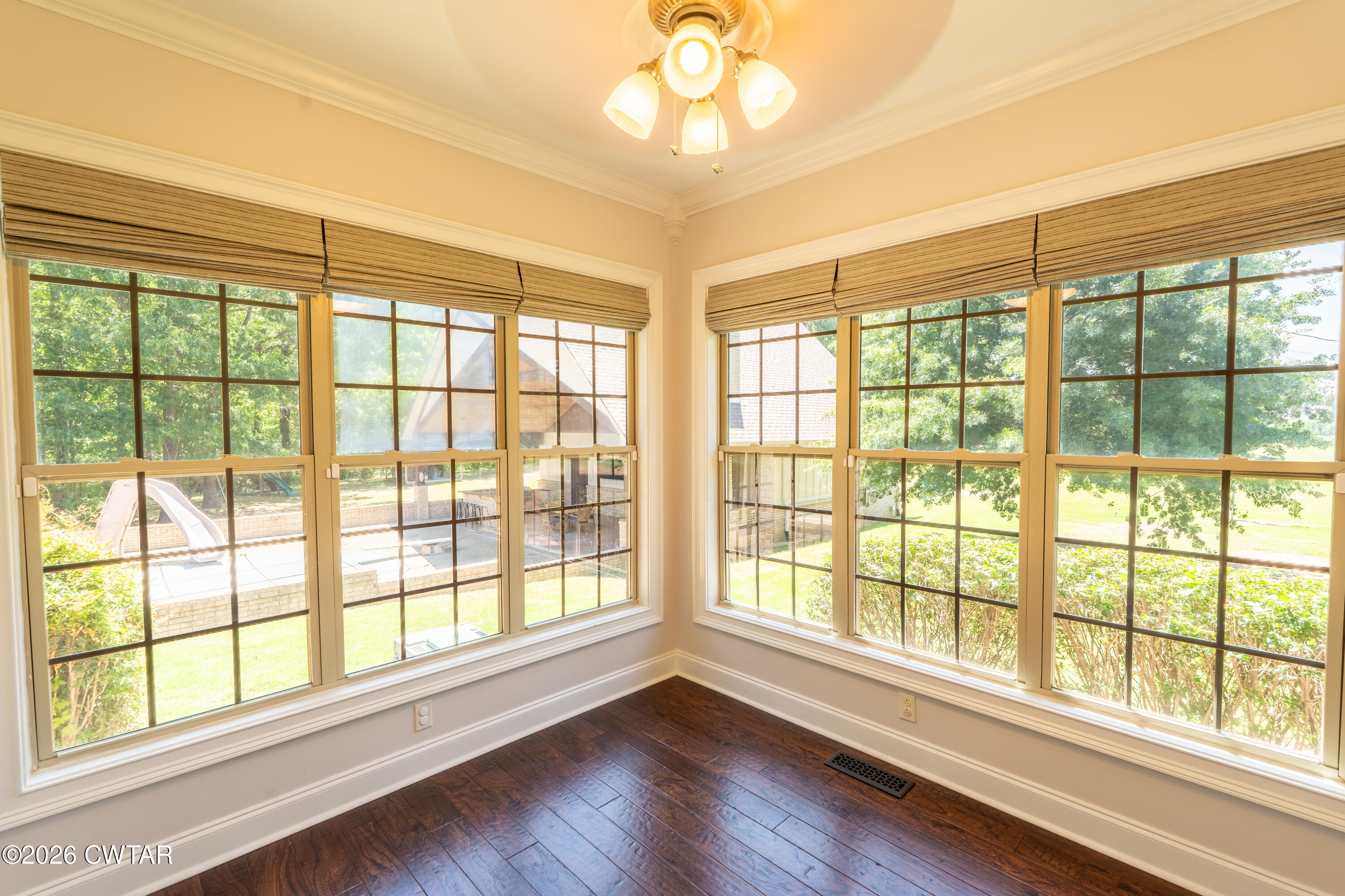 227 Willie Johnson Road Dyersburg, TN 38024 - Photo 14 of 43 a view of an empty room with wooden floor and a window