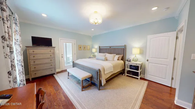 a bedroom with a bed and a television