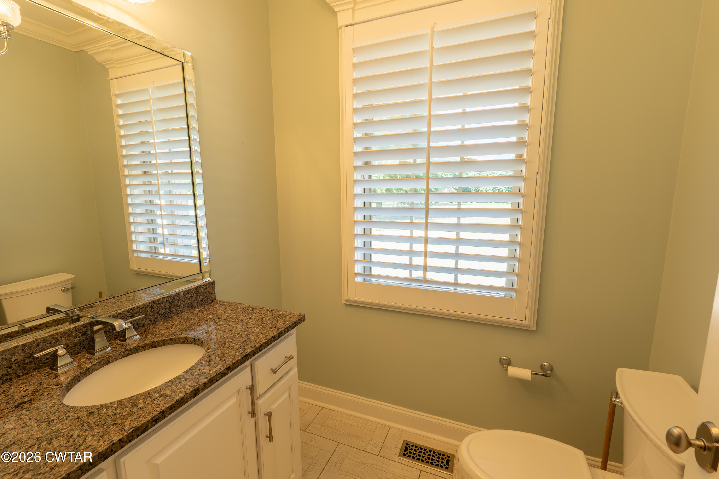 227 Willie Johnson Road Dyersburg, TN 38024 - Photo 21 of 43 a bathroom with a granite countertop sink toilet and mirror