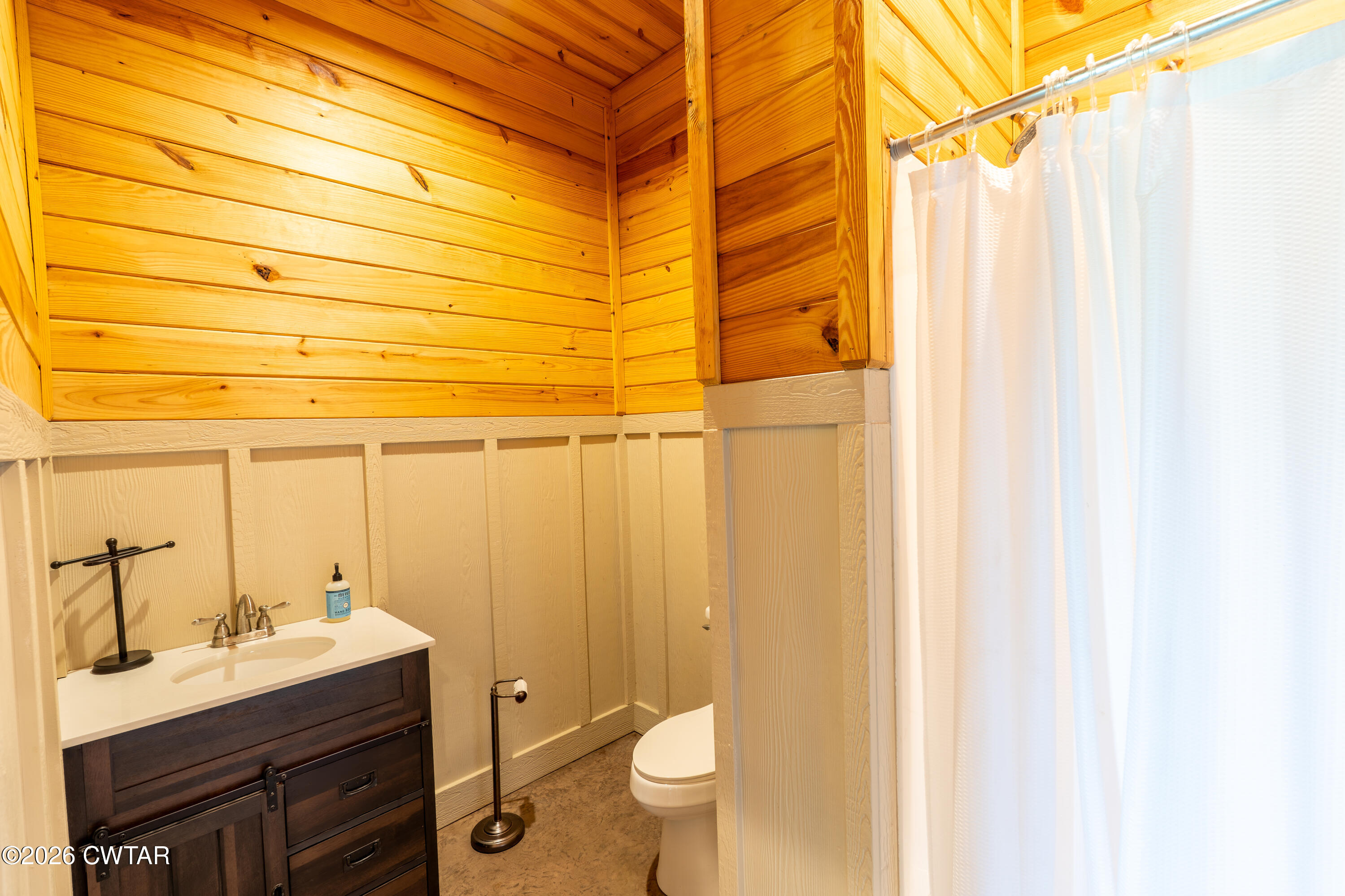 227 Willie Johnson Road Dyersburg, TN 38024 - Photo 37 of 43 a bathroom with a sink a toilet and shower curtain