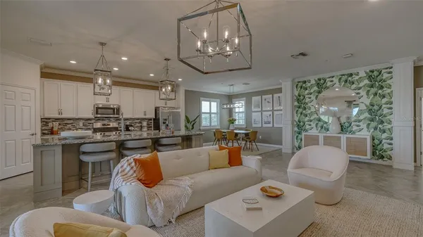 a view of a dining room with furniture and chandelier