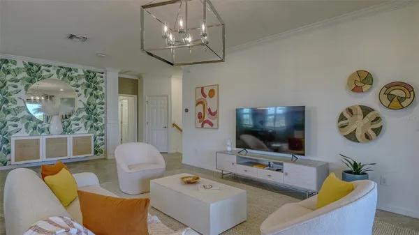 a kitchen with stainless steel appliances granite countertop a sink dishwasher a refrigerator a stove a dining table and chairs with wooden floor