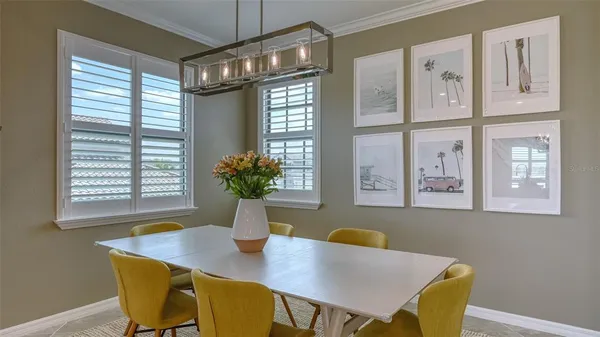a bedroom with a bed a desk and chair with a bookshelf