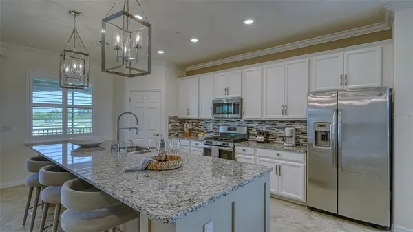 a bathroom with a granite countertop sink a mirror a vanity and shower