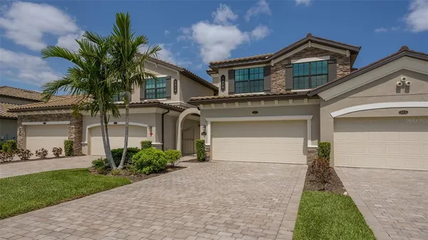 a front view of a house with a yard and garage