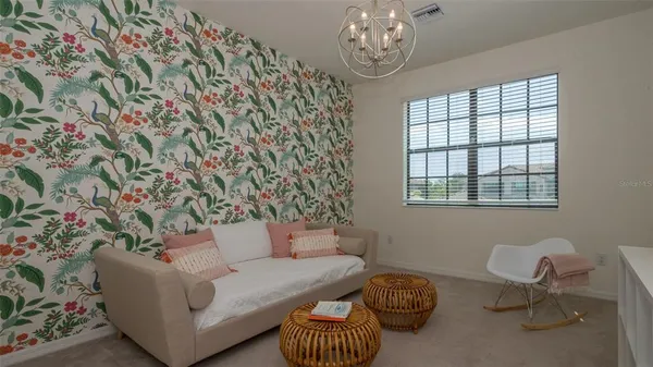 a view of a house with backyard porch and sitting area