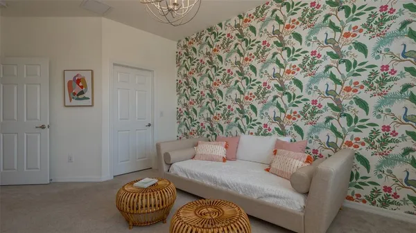 a front view of multi story residential apartment building with yard and outdoor seating