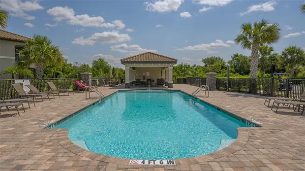 a view of a swimming pool with a table and chairs
