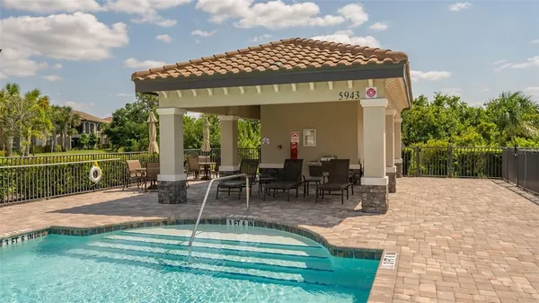 a view of a house with swimming pool and sitting area