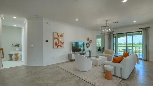 a living room with furniture wooden floor and a chandelier