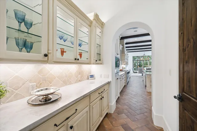 a hallway with sink and cabinets