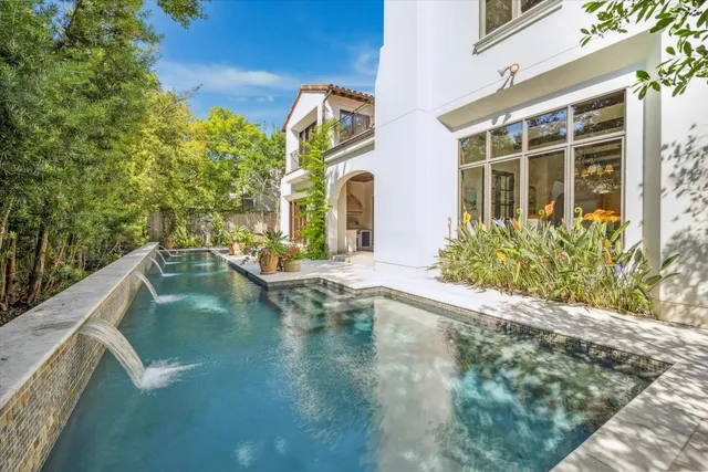 a view of a house with pool and sitting area