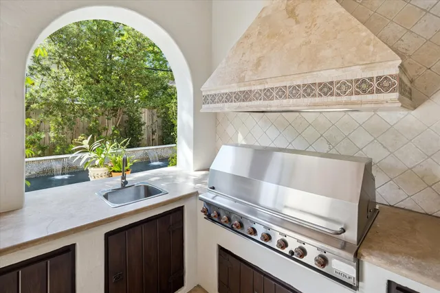 a kitchen with a sink a stove and a wooden floors