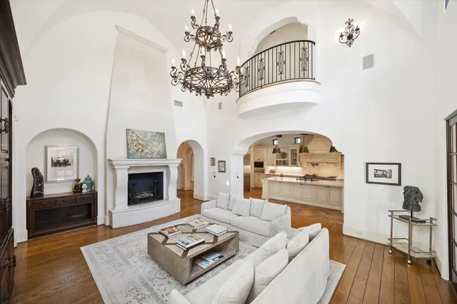 a living room with furniture a fireplace and wooden floor